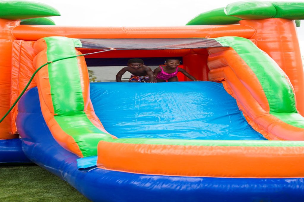 Kids playing in a water slide rental