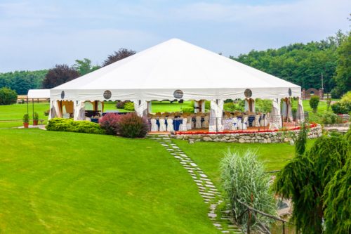 Outdoor wedding reception in tent